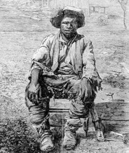 Black American man sitting in a farm setting